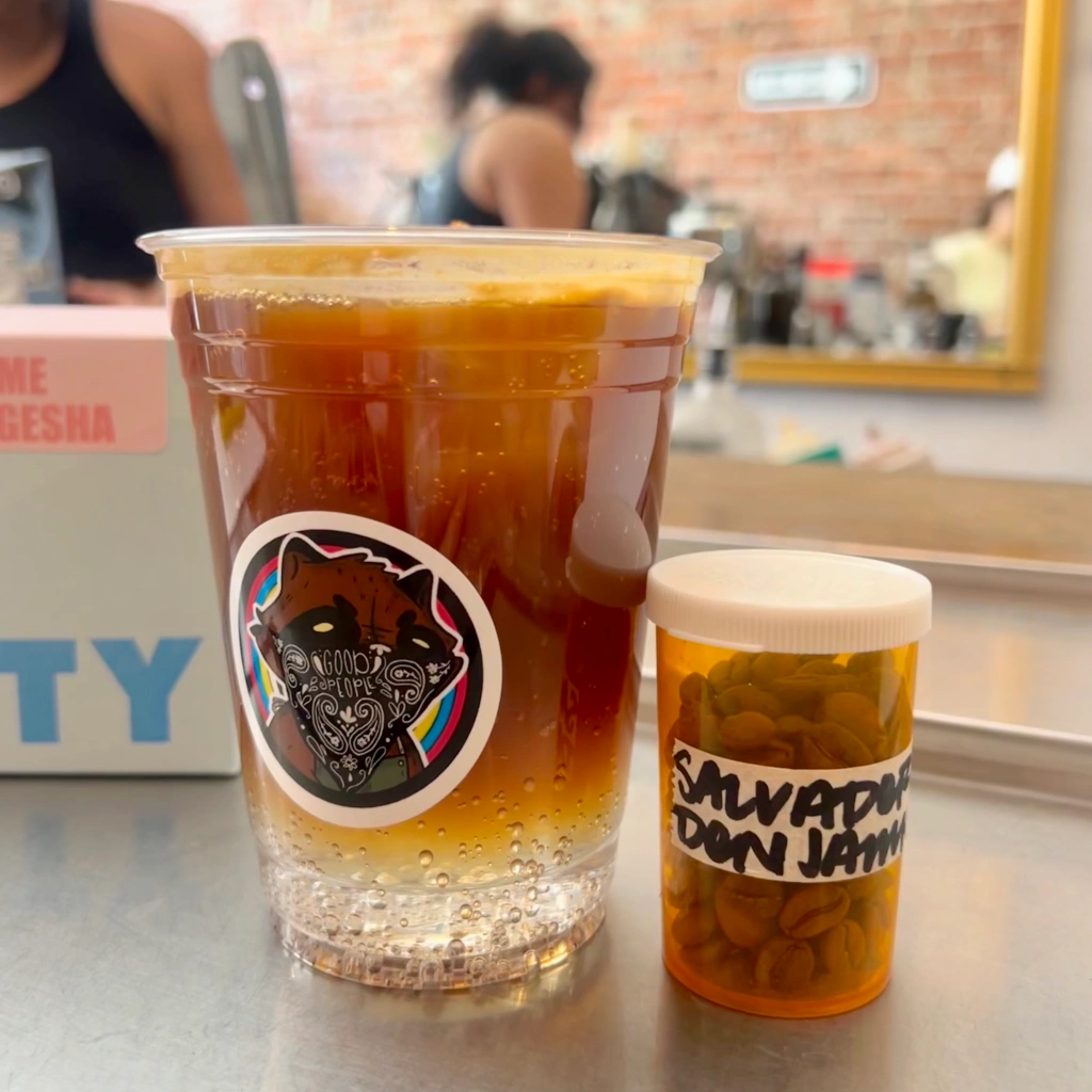 Iced Espresso Tonic beverage at GoodPeople on Santa Monica Blvd next to the Don Jaime orange prescription pill bottle filled with pre-dosed coffee beans