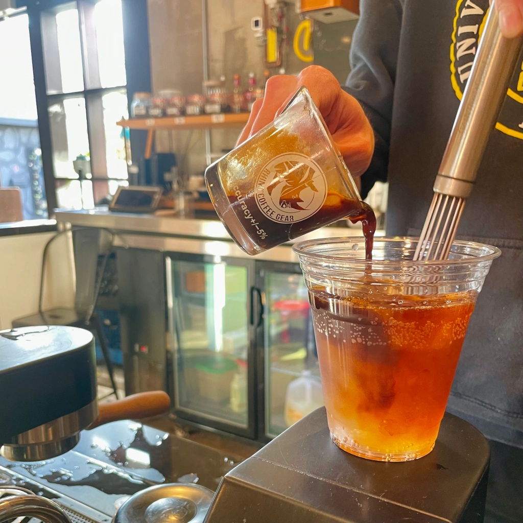 Espresso being poured by hand into a cup for a coffee mocktail at Smoky Hollow Coffee Roasters in El Segundo